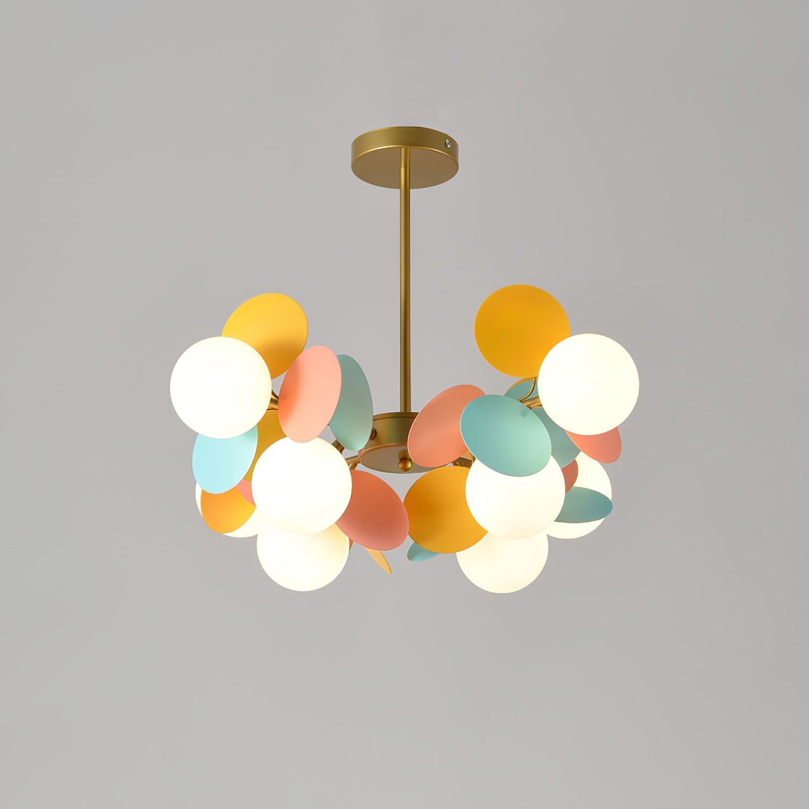 Close view of the open glass shades and gold branch arms of the tree chandelier
