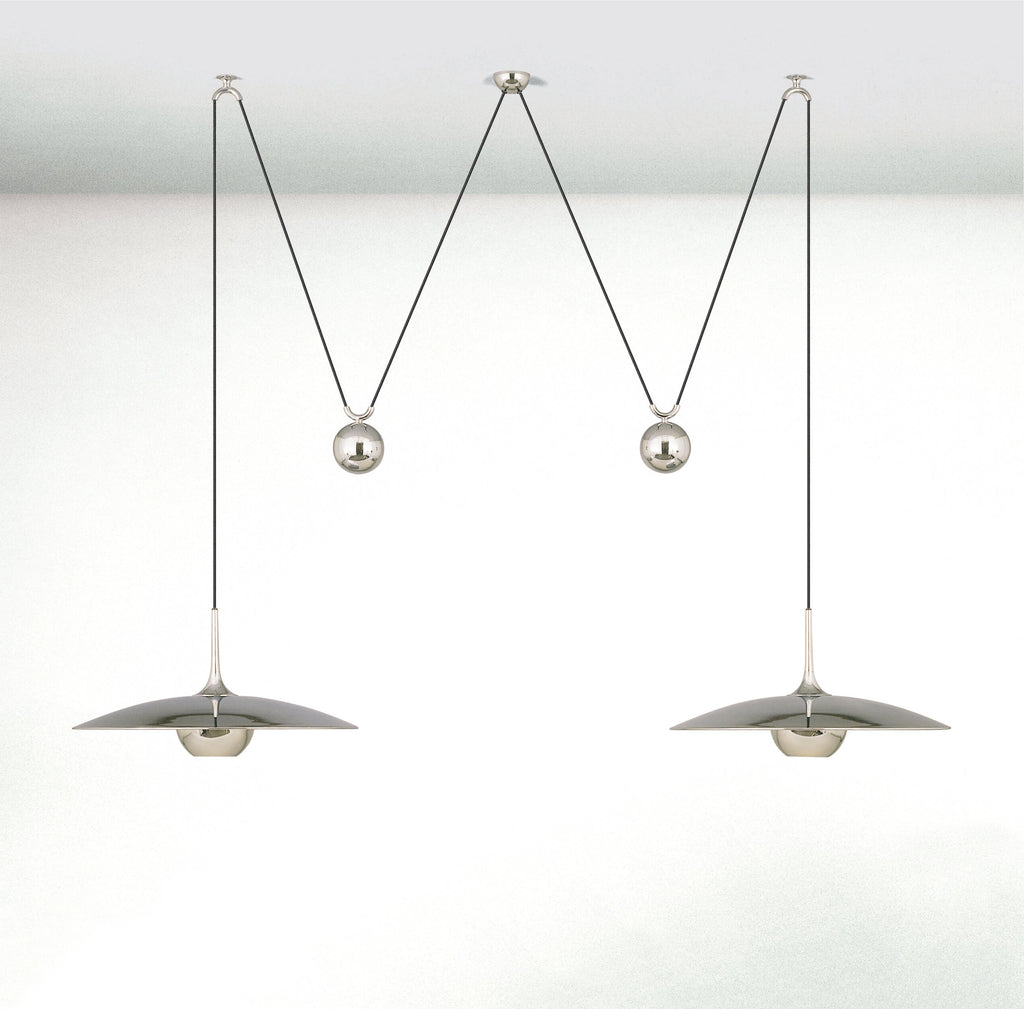 Round pendant light shown lit in a dim interior