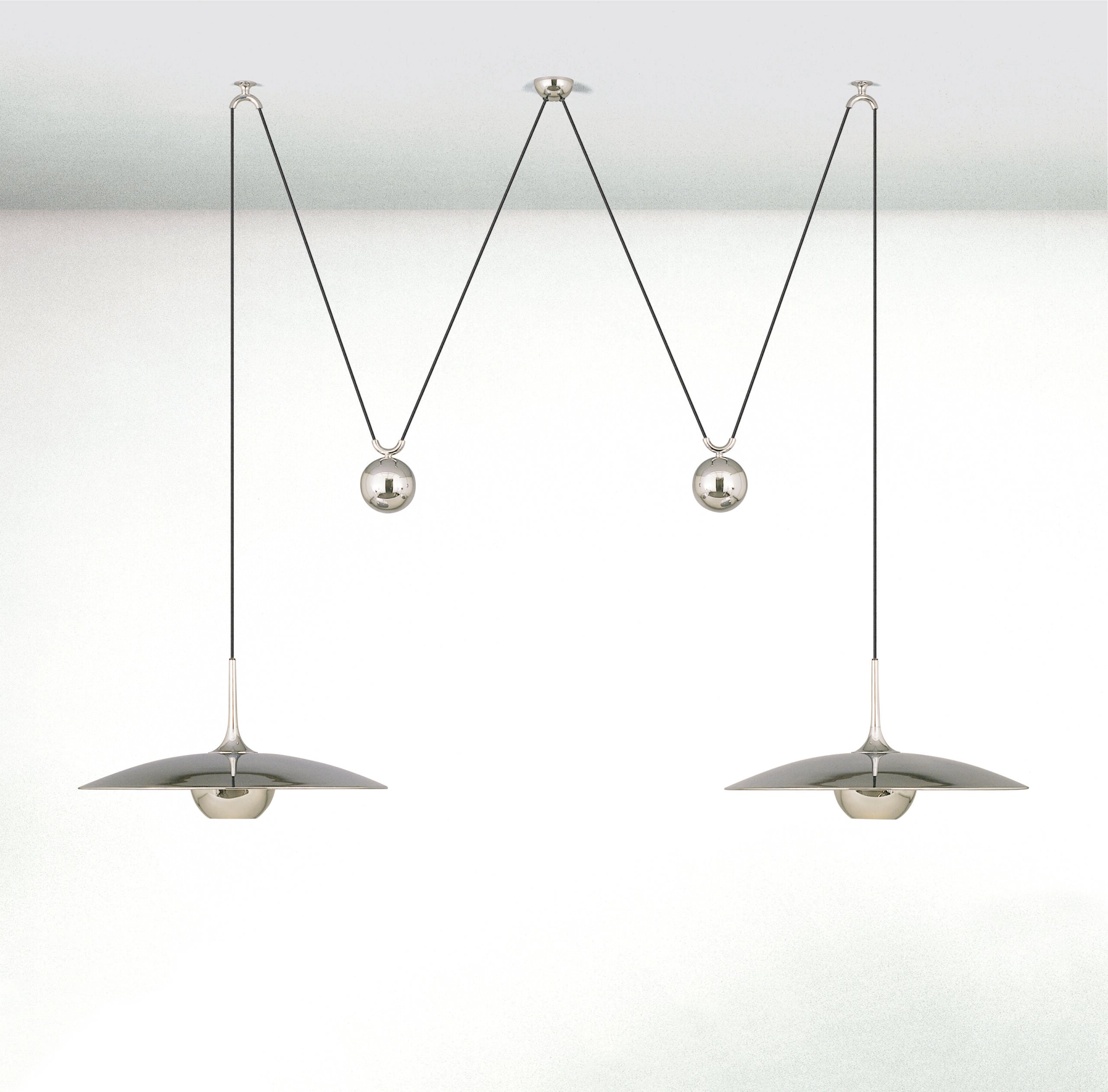 Round pendant light shown lit in a dim interior