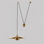 Metal pendant light detail showing the hanging cable