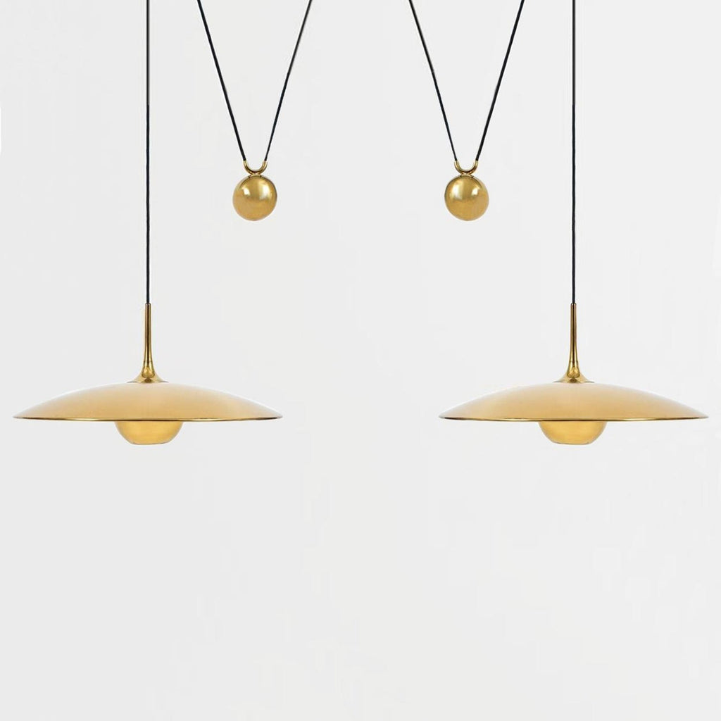 Globe pendant light with adjustable cable over a table
