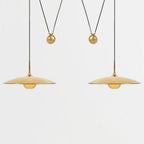 Globe pendant light with adjustable cable over a table
