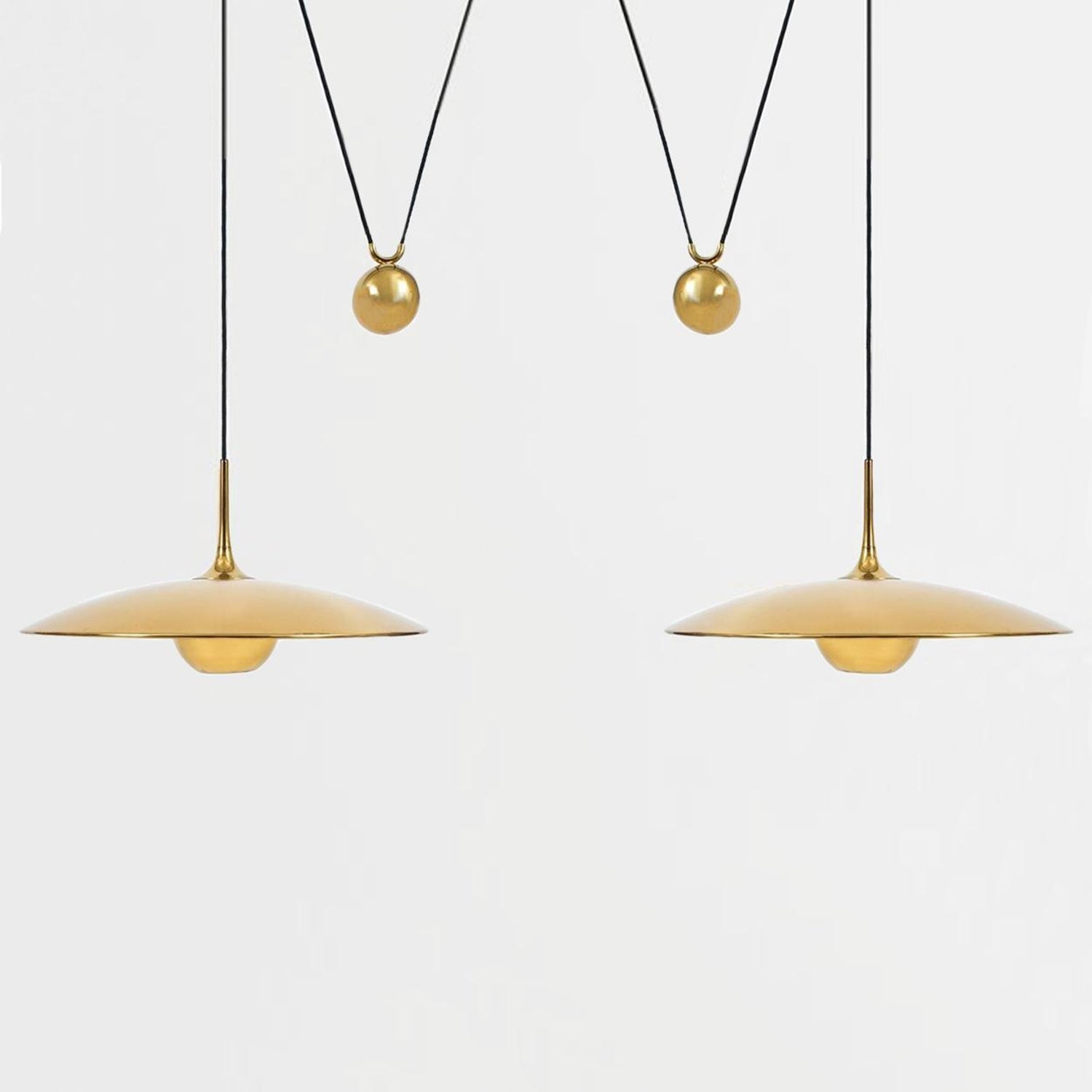 Globe pendant light with adjustable cable over a table