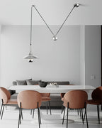 Metal pendant light casting soft light over a table