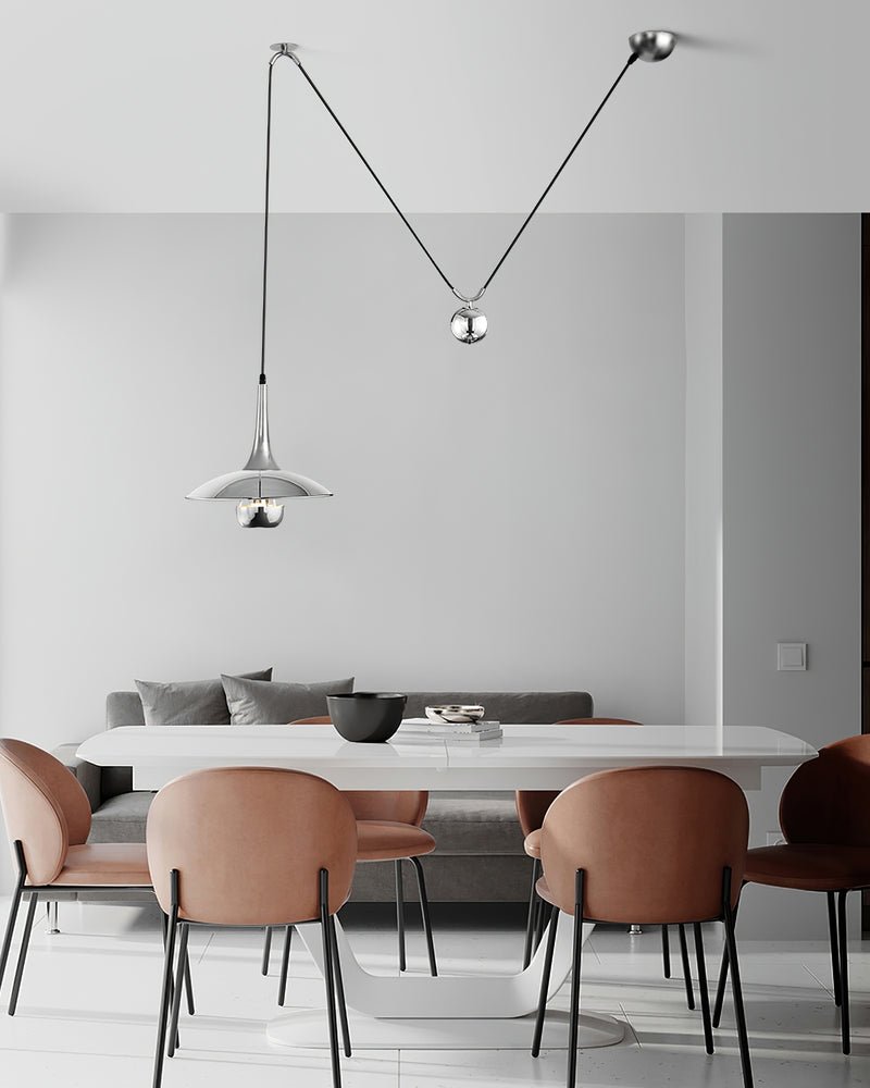 Metal pendant light casting soft light over a table