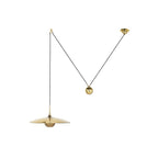 Metal pendant light hanging above a seating area