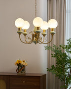 Gold-finish chandelier shown against a dark backdrop
