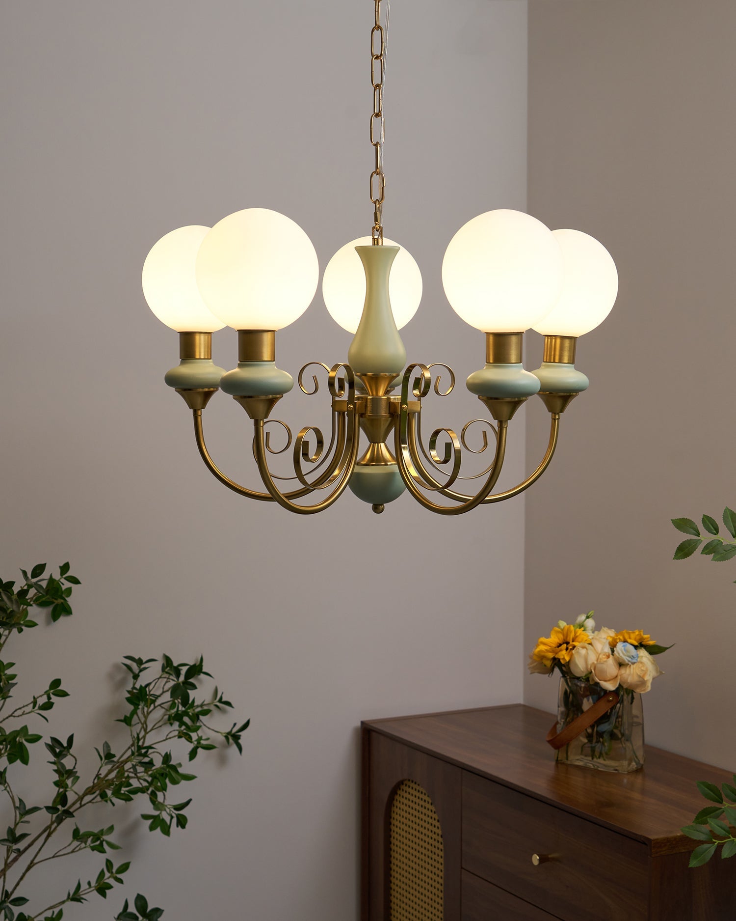 Gold chandelier with warm glowing glass shades