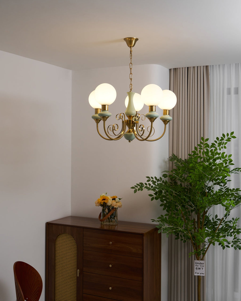 Multi-head chandelier with warm light over a table