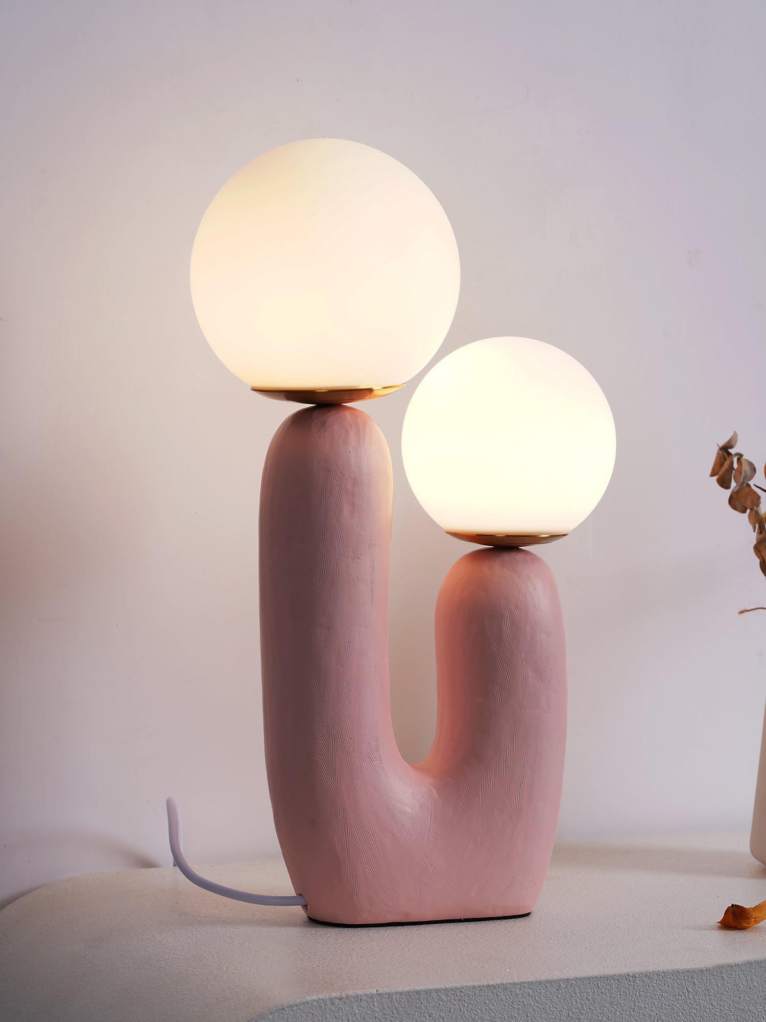 White glass globe table lamp shown close up lit