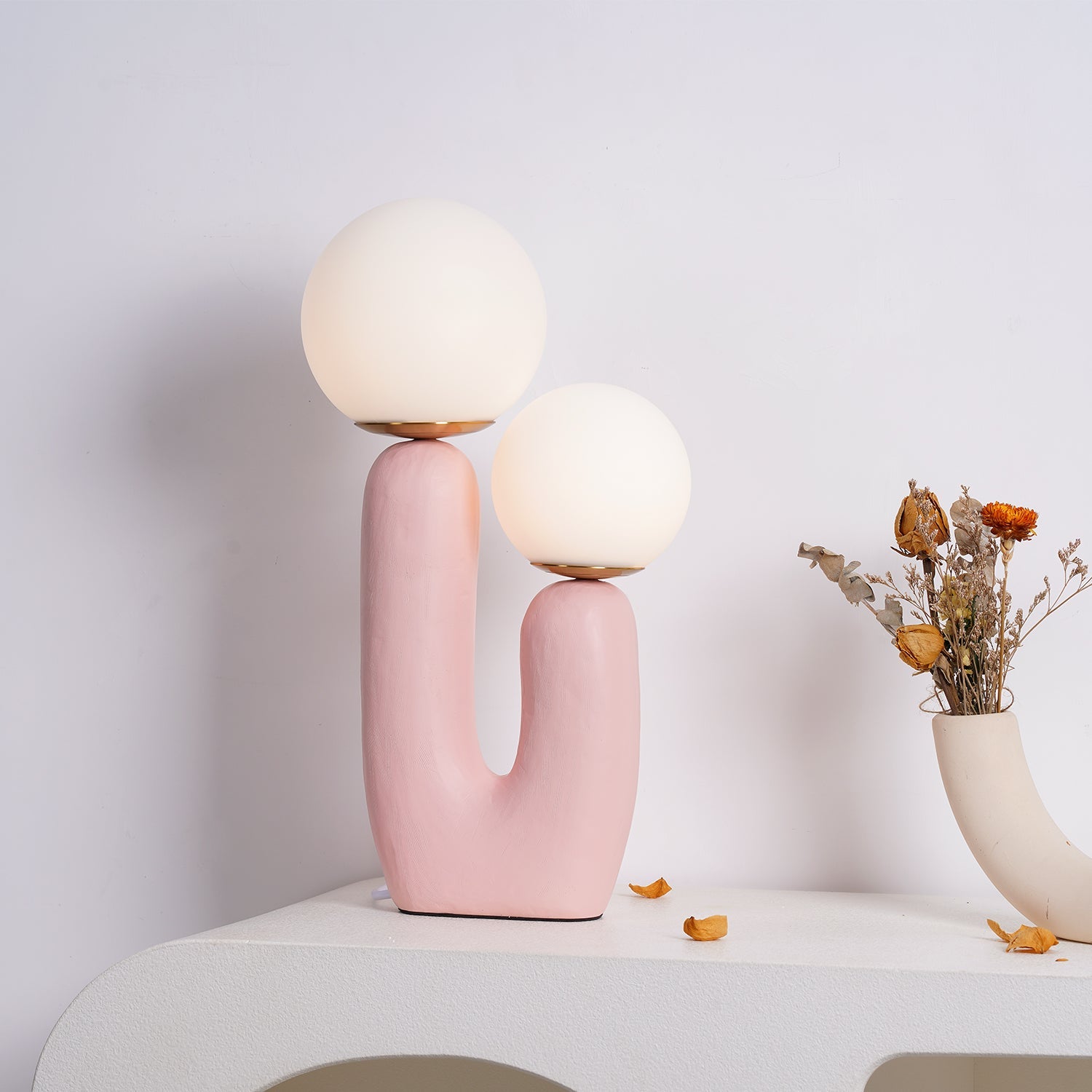 White glass globe table lamp glowing in the evening