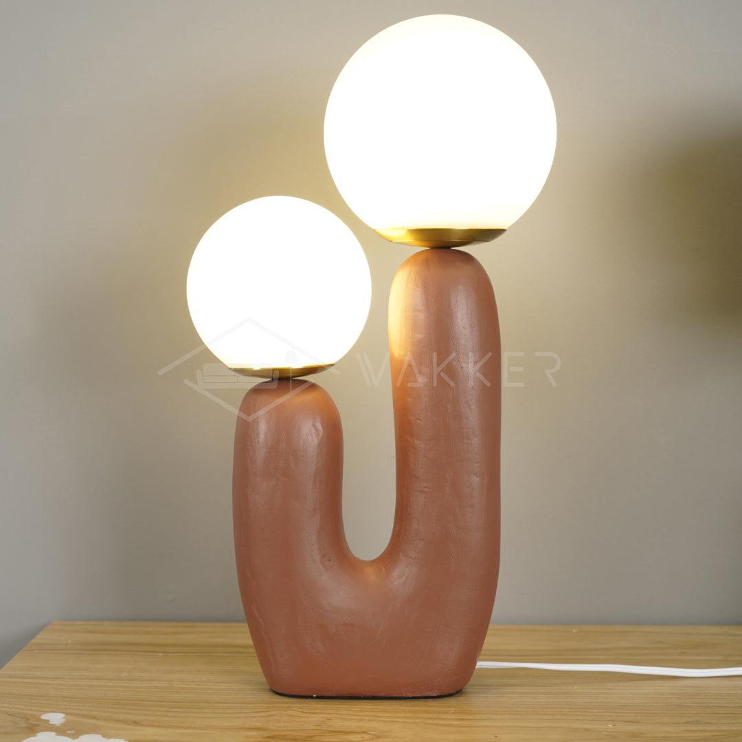 Original table lamp with rounded body and glass globe