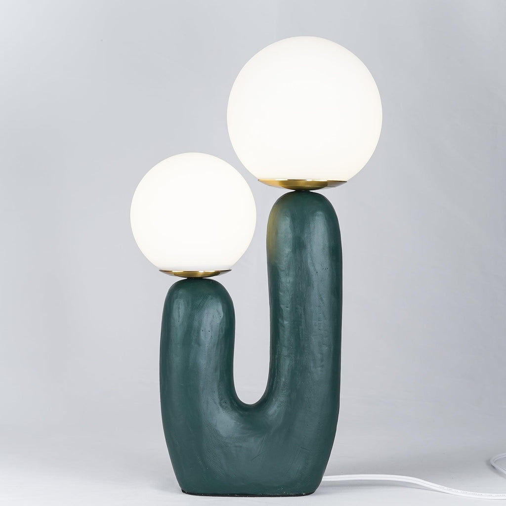 White glass globe table lamp shown switched on
