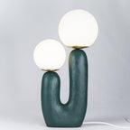 White glass globe table lamp shown switched on