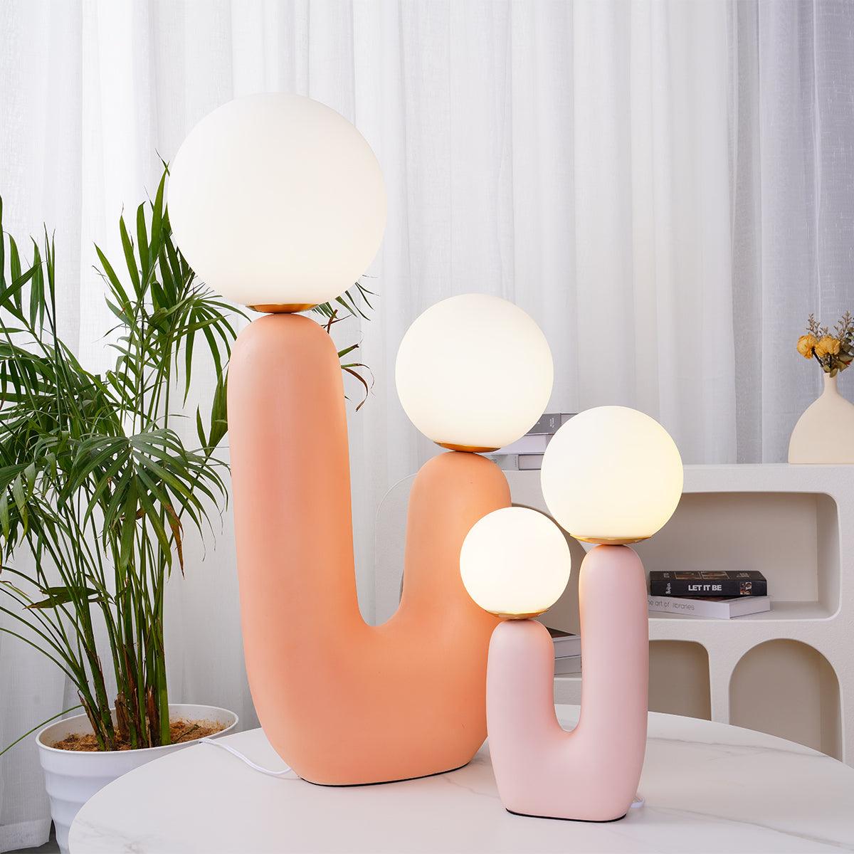 Table lamp with rounded body and white glass globe lit