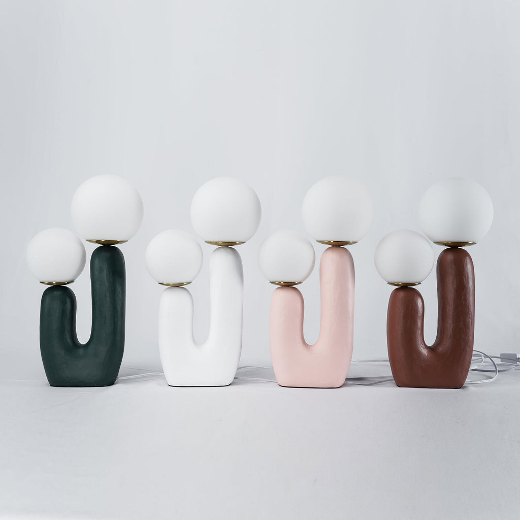 Sculptural table lamp with soft white glass glow