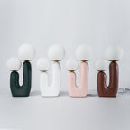 Sculptural table lamp with soft white glass glow