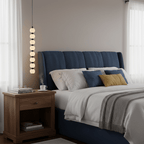 Eight-ball Orbique pendant hanging beside a navy bed and a wooden nightstand by sheer curtains