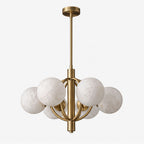 White-background view of this Clérachic chandelier in brushed brass, its alabaster shades clustered around an open ring.
