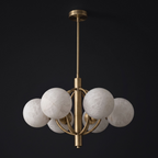 Studio view of this Clérachic chandelier in brushed brass, alabaster balls held within a ring-frame cage.