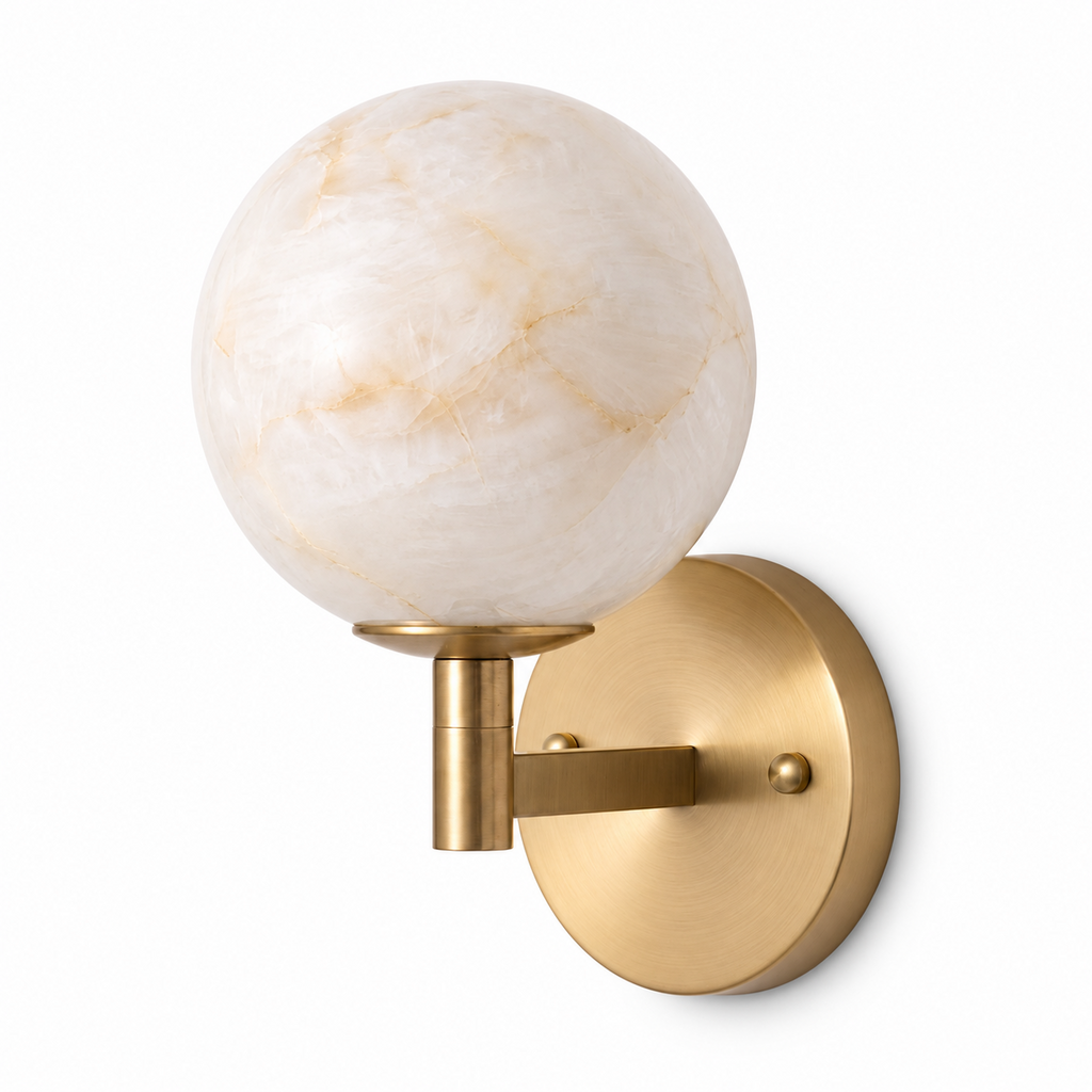 Shown in full on a plain background, this Clérachic sconce's brass arm rises to a single glowing alabaster globe.