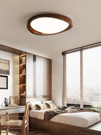Curved edge wooden ceiling light seen from directly below