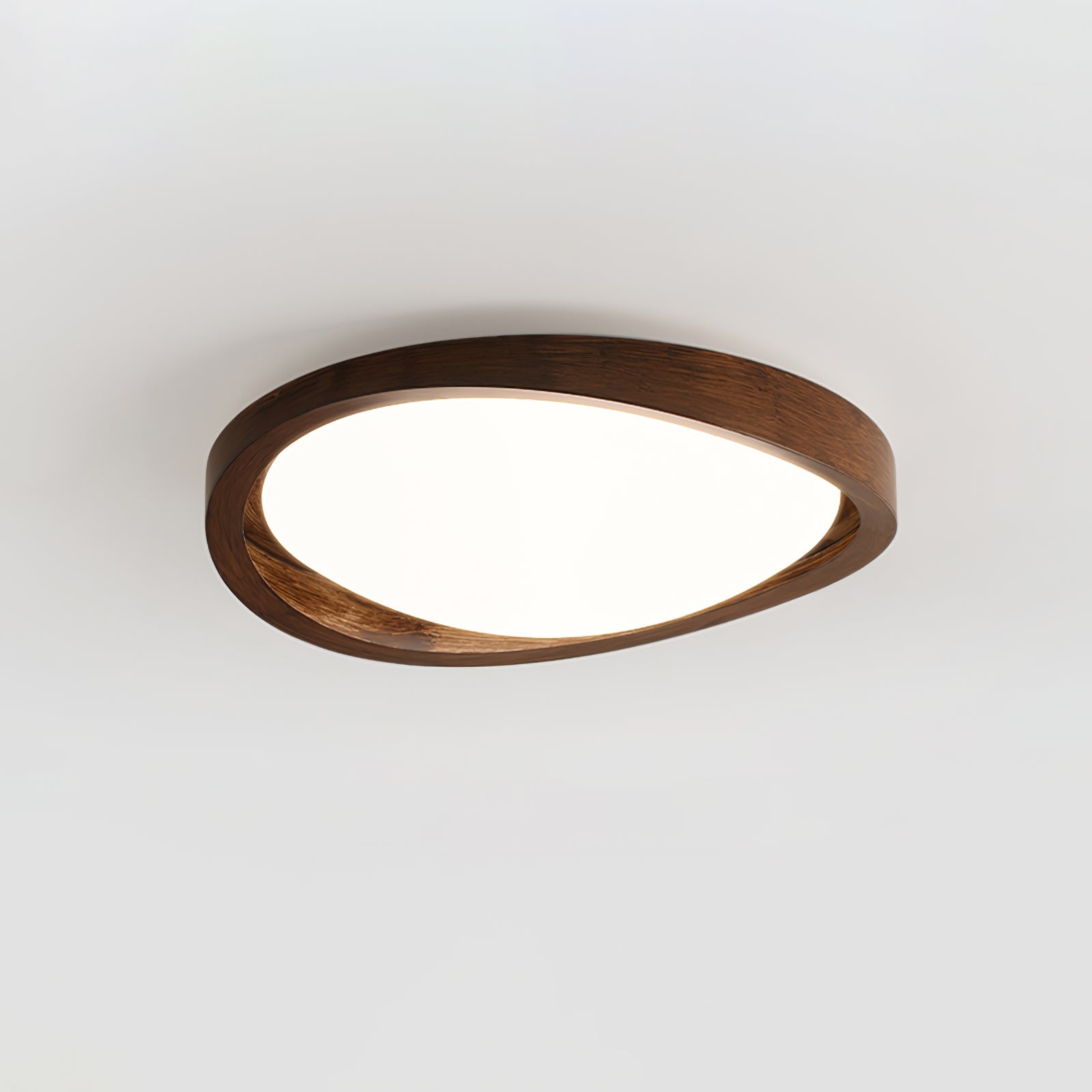 Round walnut ceiling light casting soft light on a ceiling