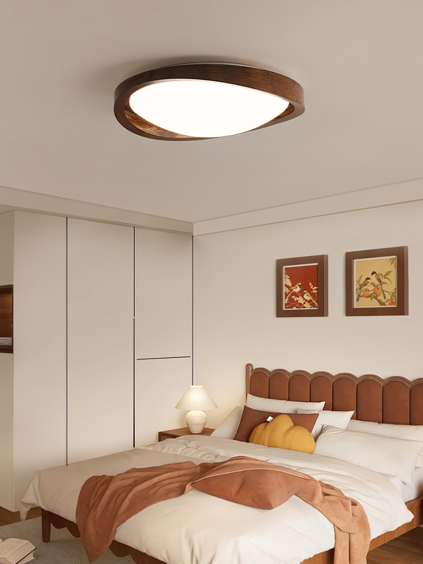 Round walnut ceiling light lighting a calm interior space