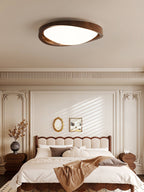 Walnut flush mount ceiling light glowing above a styled room