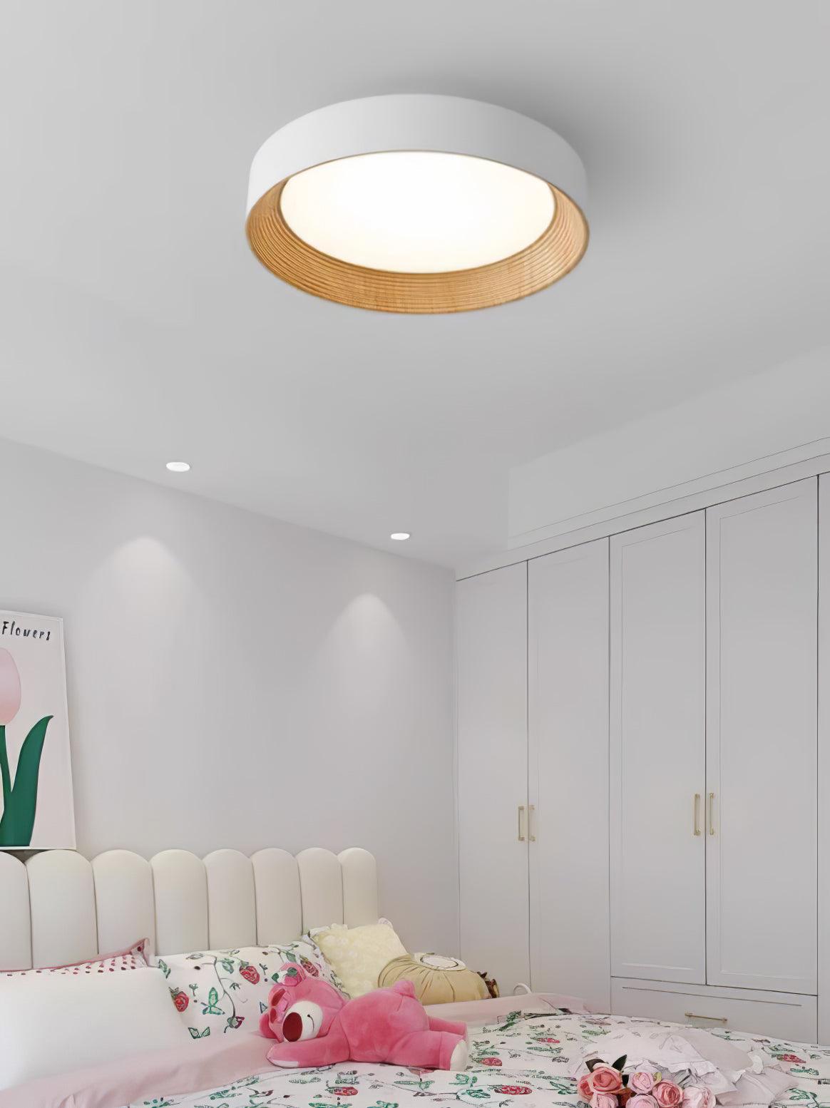 Wood-tone flush mount light against a white ceiling