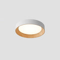 Round wood-tone flush mount ceiling light glowing softly