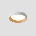 Round wood-tone flush mount ceiling light glowing softly