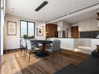 Clérachic pendants hang above a black dining table in an open-plan kitchen with wood flooring and mountain views.