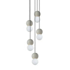 Several pale grey and white sphere pendants from this Clérachic collection hang together at different heights on thin black cords.