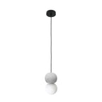 This Clérachic pendant, a grey stone-textured sphere above an opal glass globe, hangs from a black ceiling canopy on white.
