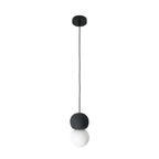 A dark stone-textured sphere tops this Clérachic pendant, its opal glass globe glowing beneath on a long black cord.