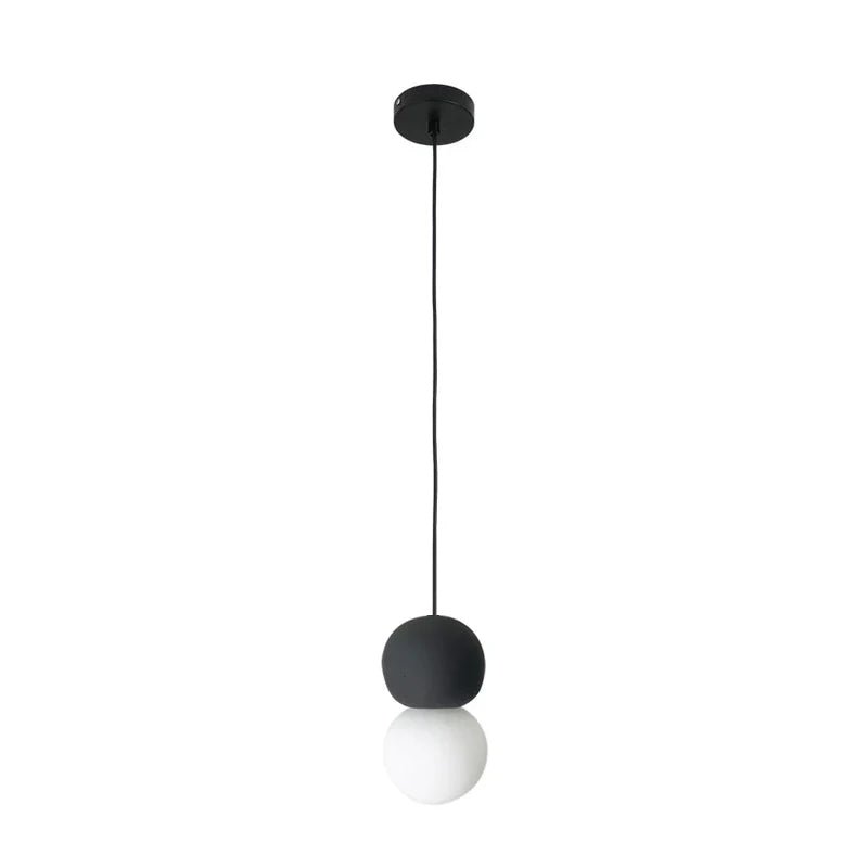 A dark stone-textured sphere tops this Clérachic pendant, its opal glass globe glowing beneath on a long black cord.