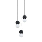 A two-light cluster of Clérachic pendants hangs together, dark stone spheres paired with opal glass globes at different heights.