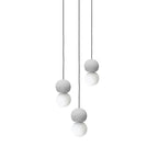 A cluster of pale sphere pendants from this Clérachic collection hangs at staggered heights against a plain white background.