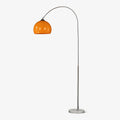 A Clérachic arc floor lamp with a nickel curve and orange dome shade stands on its round marble base against plain grey.