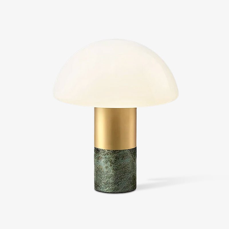 Lit against a warm off-white backdrop, the Clérachic domed glass table lamp shows its green marble base.