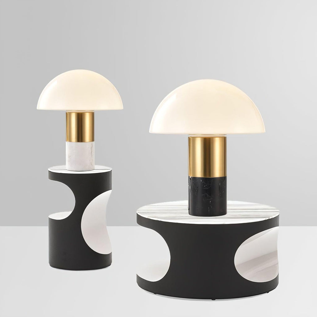 Two Clérachic domed table lamps, in different sizes, stand together on dark pedestal bases patterned with moon cut-outs.