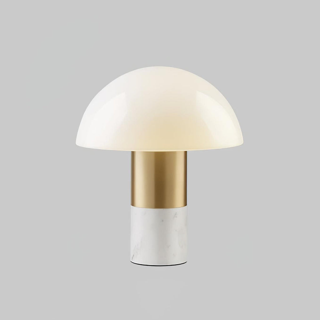 A second studio view of the Clérachic domed table lamp with a white marble base, its glass shade catching a soft highlight.