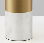 Close-up of the white marble base and brushed gold neck of a Clérachic domed table lamp, its shade out of frame.