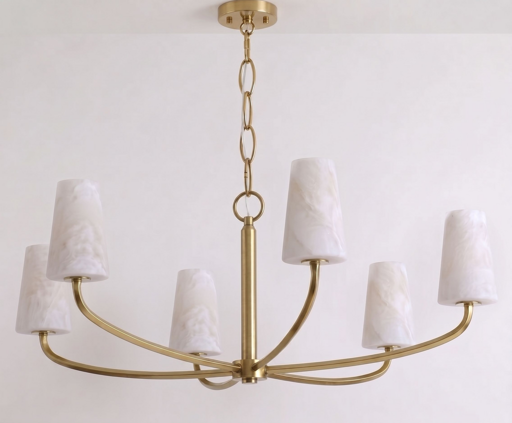Close on the ring joint between chain and frame, this Clérachic chandelier appears here in brushed brass.