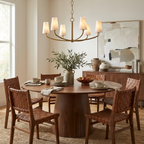 Beside a walnut sideboard with olive branches, this Clérachic chandelier hangs above a round table in brushed brass.
