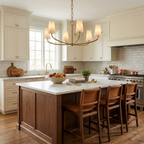 Above a cream kitchen island with wood barstools, this Clérachic chandelier's woven frame glows in brushed brass.
