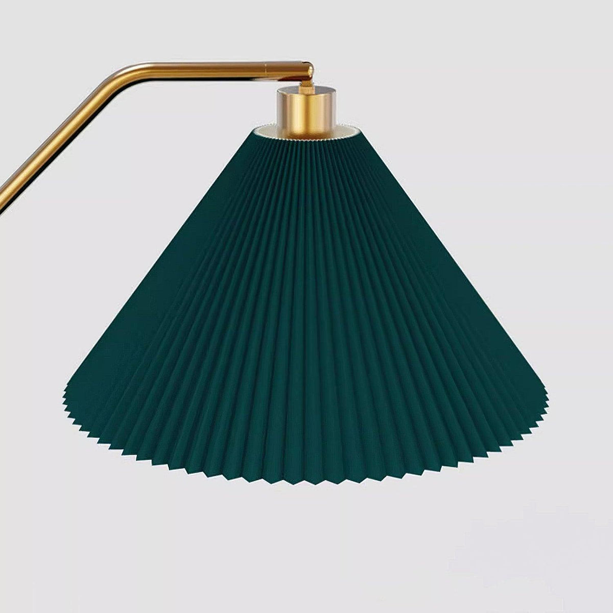 Close-up of the Clérachic floor lamp's pleated green fabric shade and brass gallery, showing the ribbed pleating in detail against a plain background.
