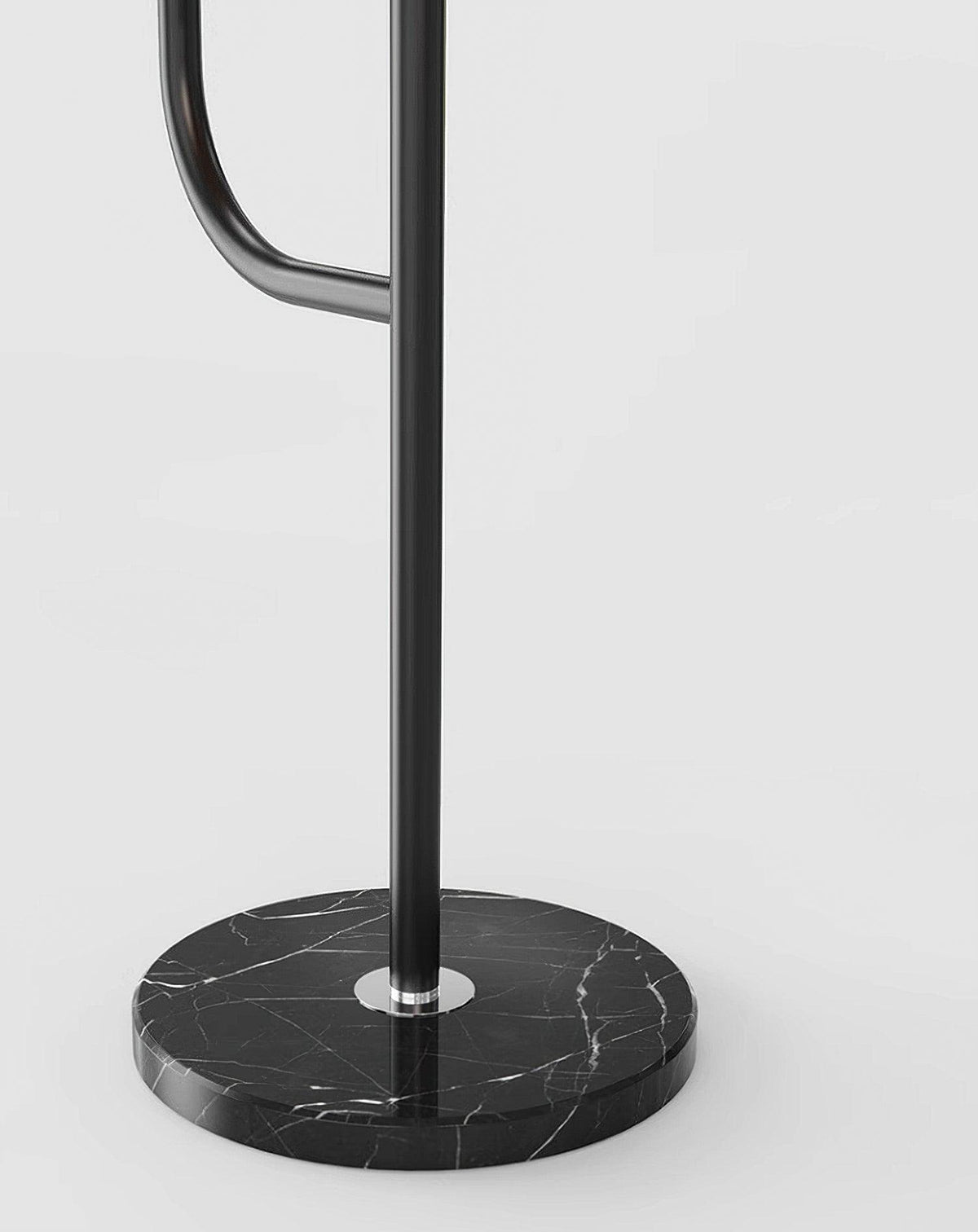 Close-up of the Clérachic floor lamp's black marble base and black pole, showing the veining in the stone against a plain background.