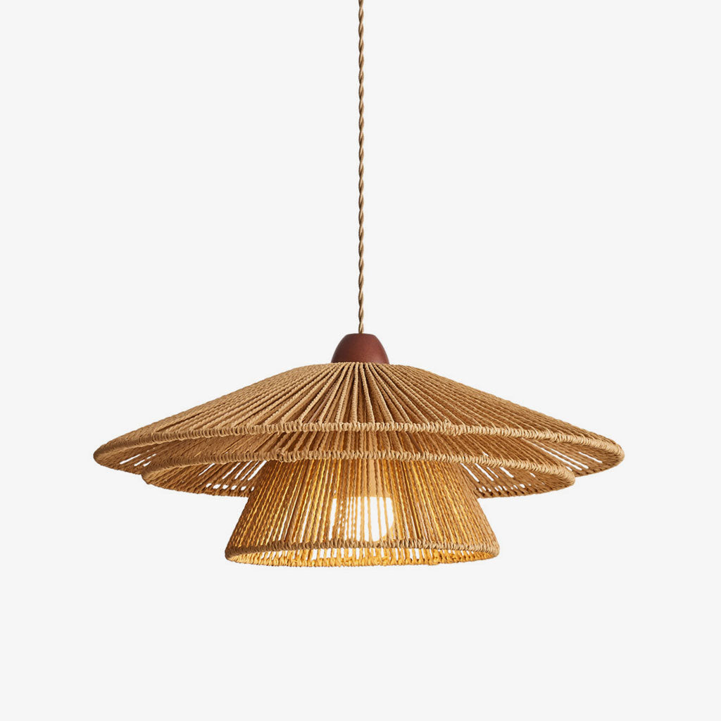 This Clérachic pendant, its two woven paper-twine tiers topped with a walnut wood cap, shown glowing against a plain background.